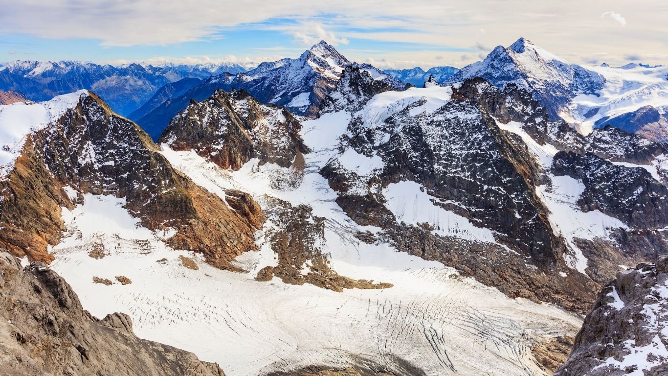 Scenic view of the Swiss Alps mountains showcasing rugged terrain and shifting alpine weather